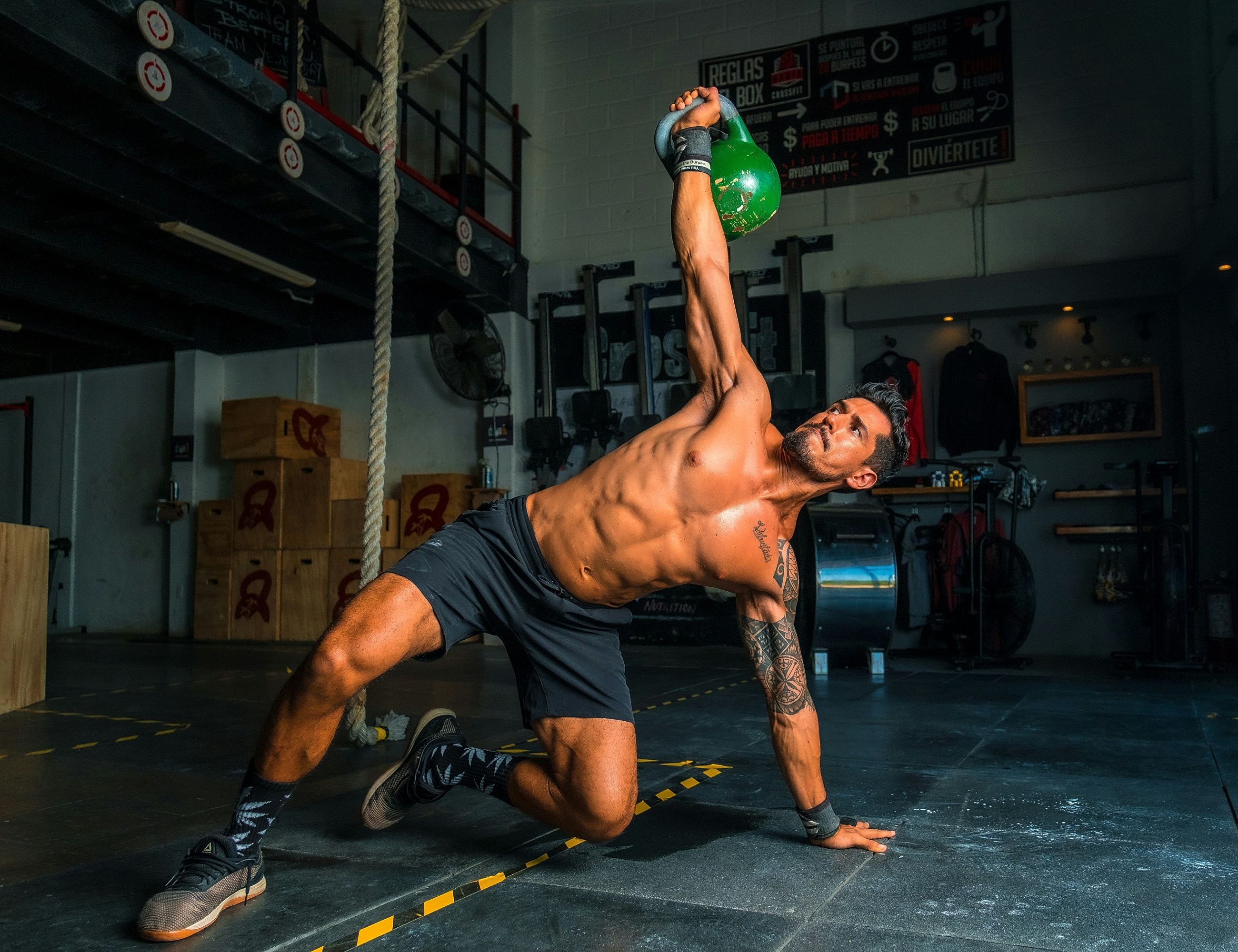 Man performing kettlebell workout in gym.