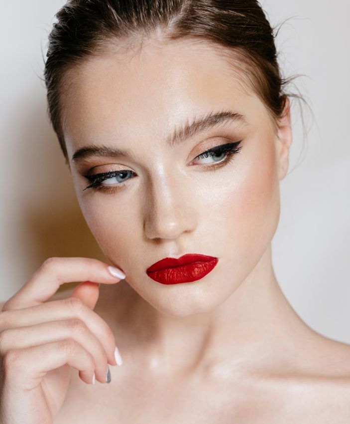 hydrafacial villanova feature - woman with dark hair and red lipstick